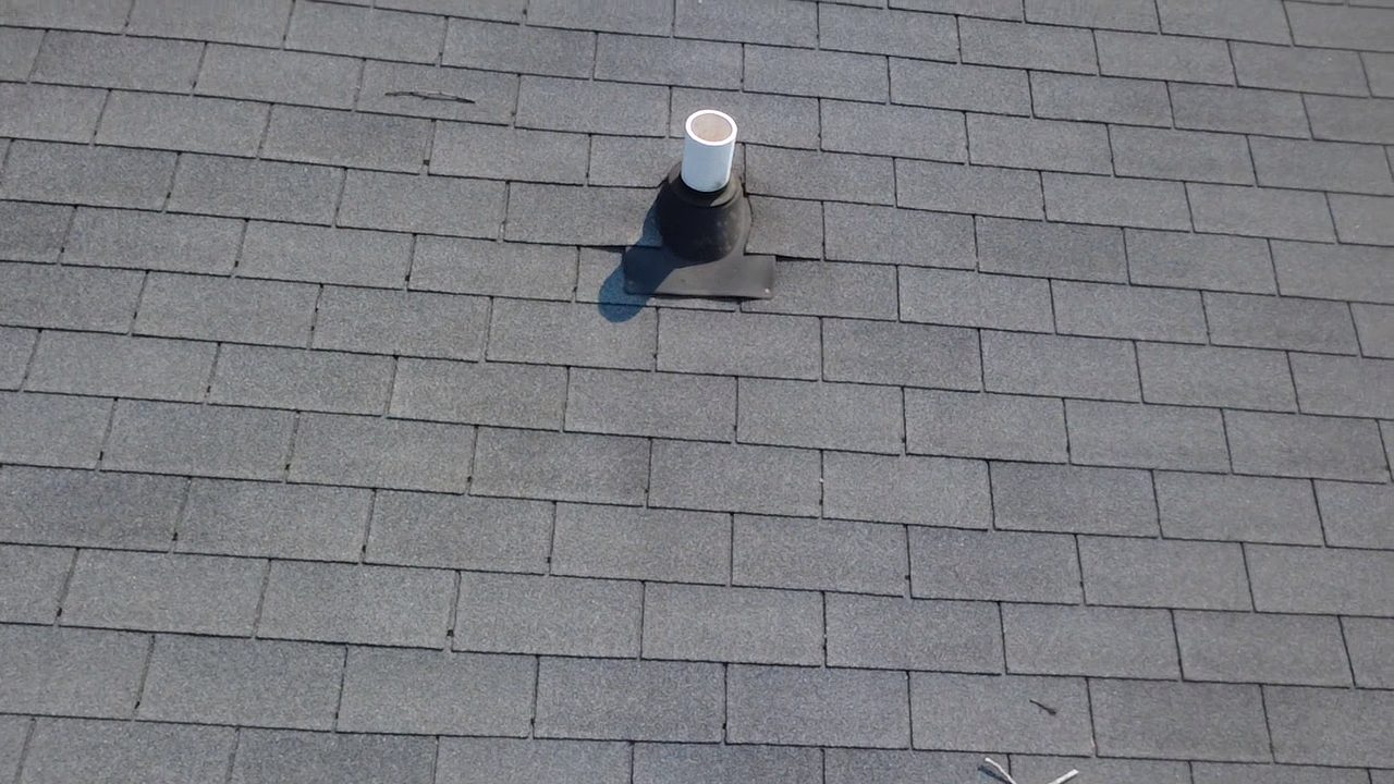 Close inspection photo of a pipe boot penetration on a shingle roof