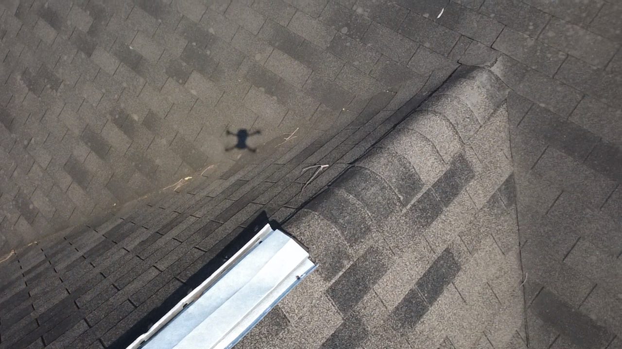 Inspection photo of a roof valley and roof-to-roof transition