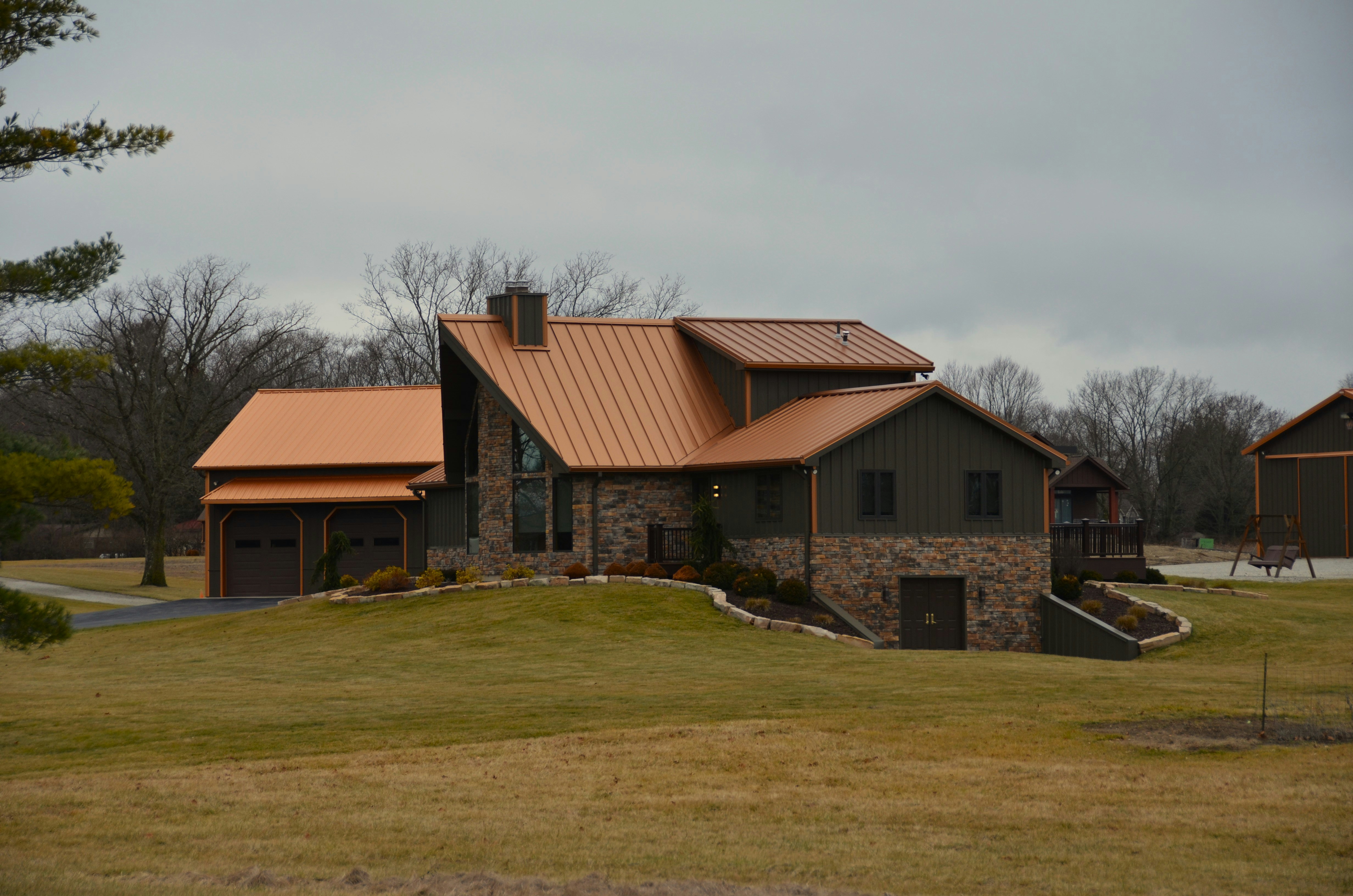 Copper standing-seam roof accent on a luxury home turret