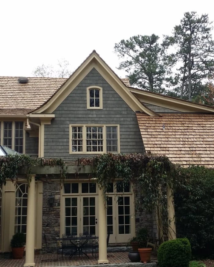 Shingle-sided estate with a new cedar shake roof by Vest Construction