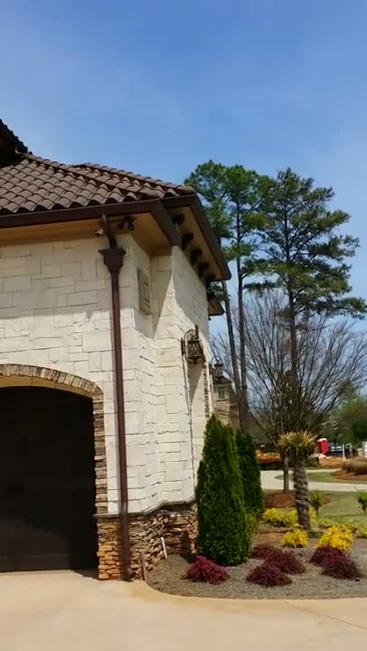 Video tour of a stone home with clay tile roof and copper gutters by Vest Construction